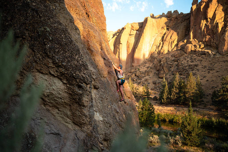 A climber on the orange walls of Smith Rock